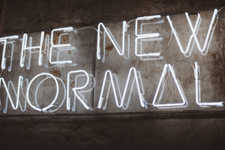 photo of neon sign saying The New Normal