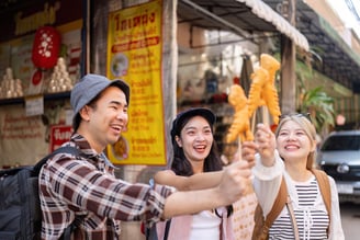 Friends celebrating their travel adventures, joyfully sharing crispy street food