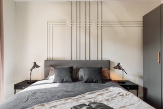 Elegant bedroom with wall panels, calm color palette and modern minimalist design in Barcelona