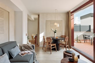 Elegant living room with contemporary design, large windows, wood elements in Barcelona