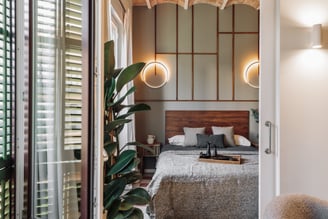 Relaxing bedroom with natural wood finishes, neutral tones, and minimalist design in Barcelona