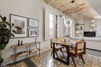 Modern dining room with exposed brick walls, tile floors and Catalan vaulted ceiling interior design
