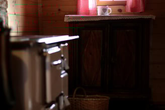 a kitchen with a stove and a basket on the counter