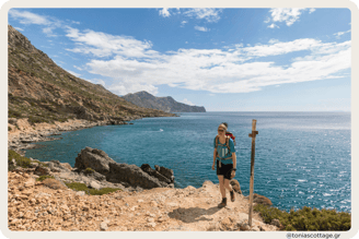 A hiker is approaching in the early morning the hidden beach of Glika Nera in Crete