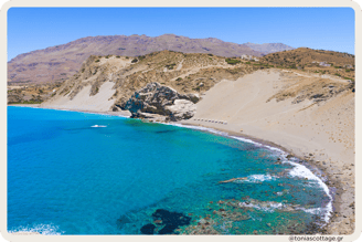 Agios Pavlos Sandhills in Crete, Greece with a scenic sea view, featuring sunbathers in the distance