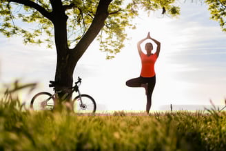 Slim beautiful woman doing yoga in morning in park.
