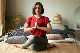 young female with grayish hair doing yoga.