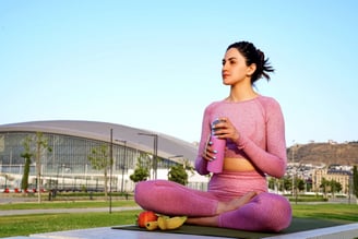 Young woman in purple shirt and trousers on the grass