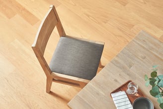 3D marketing design of a wooden dining chair with cushion seating, showcasing advanced graphic desig