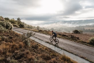 a man riding a bicycle down a road