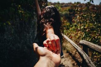 a guy holding a hand out to his girlfriend