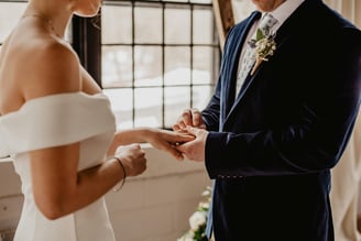 a man and woman getting married in a wedding ceremony