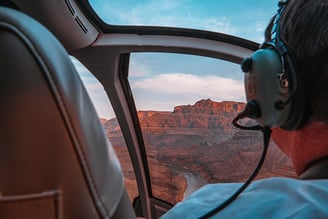 a man in a helicopter with a headset and a headset