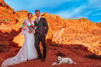a man and woman standing in front of a mountain