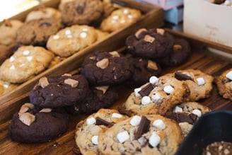 a variety of cookies and cookies on display at a bakery