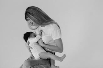 a woman holding a baby in her arms