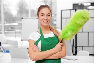 a woman in green aprons holding a green duster