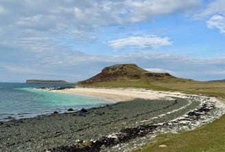 Black beach showing the clear sea