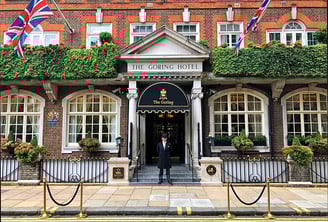 a man standing in front of a building with flags