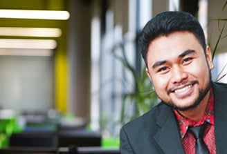 a man in a suit and tie smiling