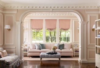 a living room with a couch and a ottoman