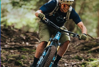 a man riding a bike in the woods