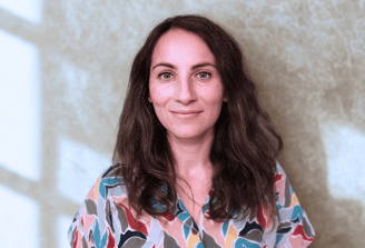 a woman in a colorful shirt and jeans