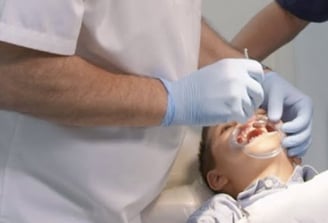 a man in a white shirt is getting ready to be a dentist