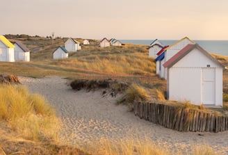 a beach with a fenced in area with a fence and shop