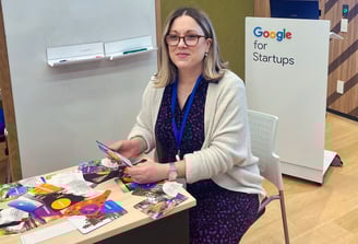 Julie Gachet Mitrovic sitting at a table with Strengths cards for a workshop at Google for Startups