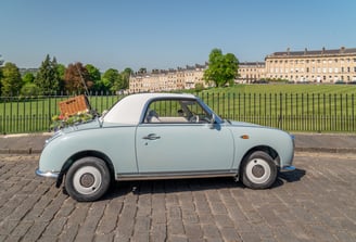 Nissan Figaro classic car with picnic basket near Royal Crescent, Bath
