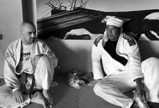 two men sitting on the mat
