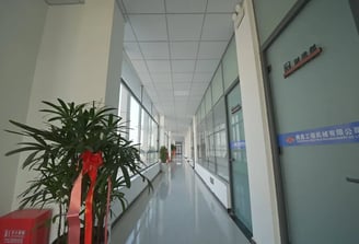 Zorulift Construction Machinery: Bright, modern office corridor to Manufacturing Dept. Clean, professional.