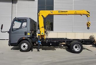 Zorylift straight arm truck crane (truck-mounted crane) in yellow, on a commercial vehicle, outrigger deployed.