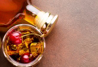 a bottle of honey syrup with cherries and cherries