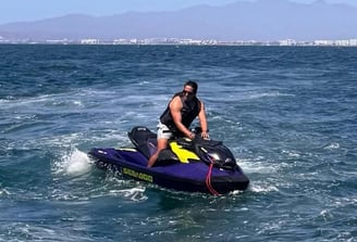 a man riding a jet ski in the ocean