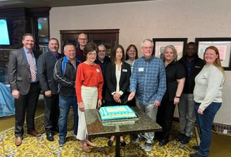 Allan Wesley Chair of Heartland Air Monitoring cutting the 25th anniversary cake with the Board