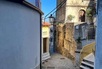 a narrow alleyway with stairs and a staircase