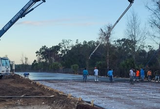 Croft Concrete boom truck and workers on a constuction site .