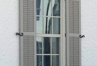 hinged exterior shutters that open and close