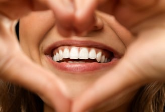 A confident person smiling after a complete smile makeover, featuring perfectly aligned and bright t