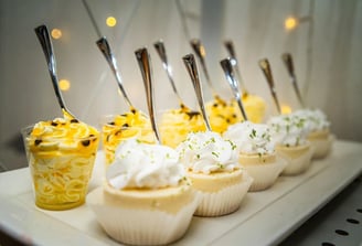 a row of desserts with spoons and spoons