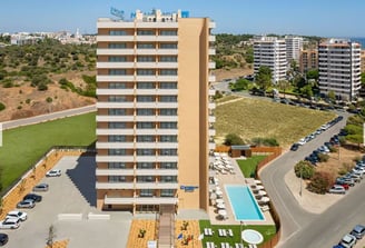 Exterior of Wyndham Residences Alvor Beach, a modern building with pool and parking 