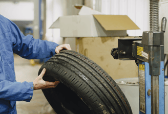 Un professionnel en tenue de travail change un pneu