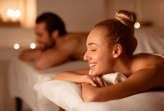 a man and woman in a spa treatment room