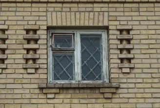 a brick building with an outdated window