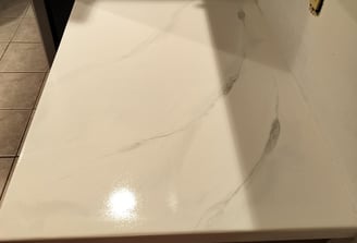 Custom white epoxy countertop with marble-style veining – seamless, glossy finish ideal for kitchens