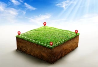 a grass field with pinpoint markers and pins on it