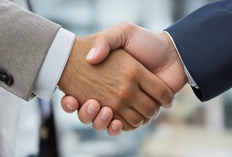 two people shaking hands with each other