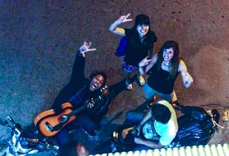 a group of people standing around a motorcycle